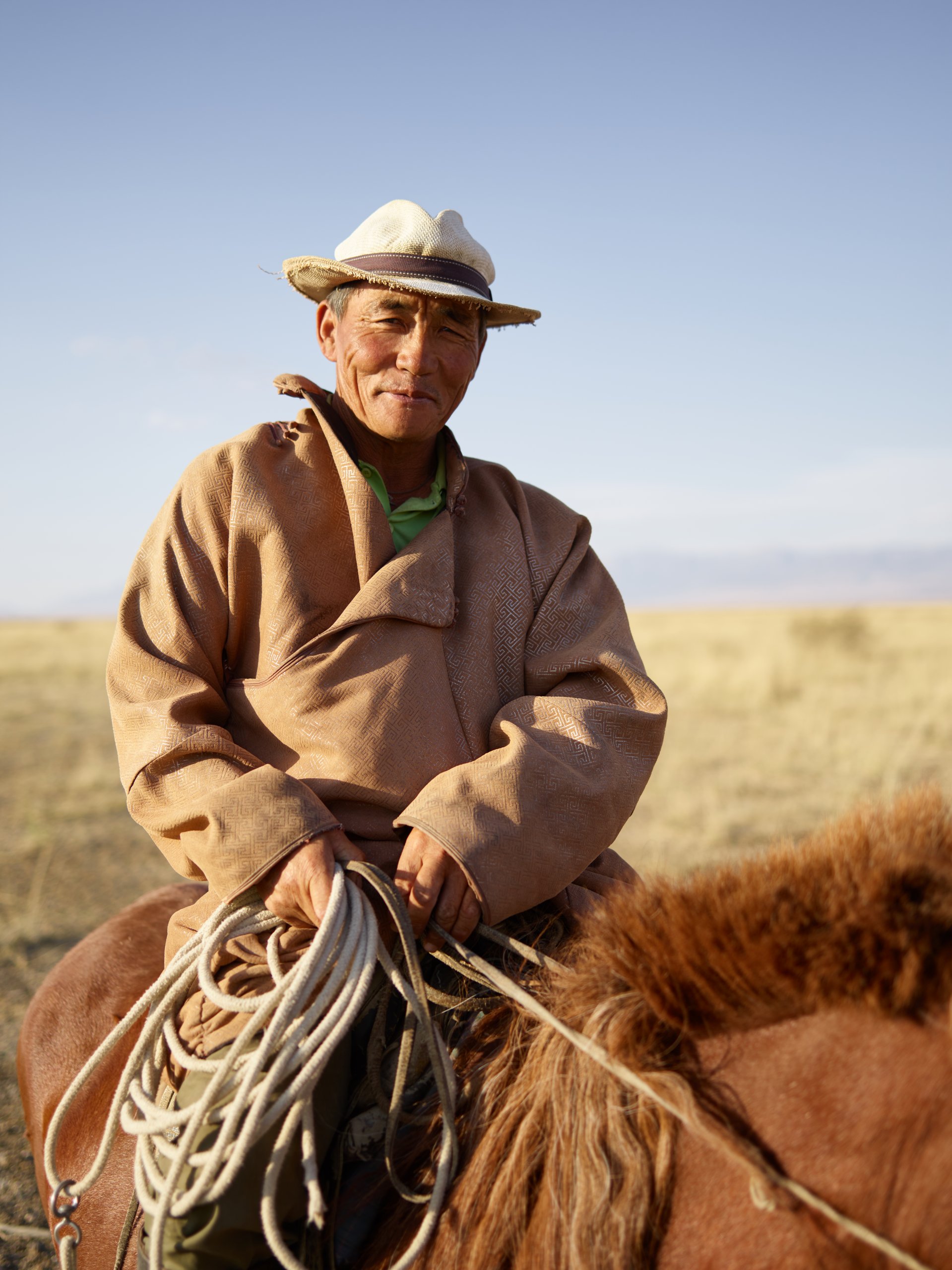 Image of a smiling, older man on horseback who looks like he has been there and done that. Article is about self development work